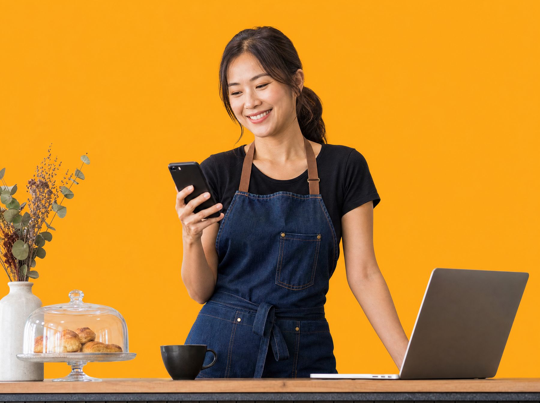 A Singapore cafe owner checking her business's marketing on her phone